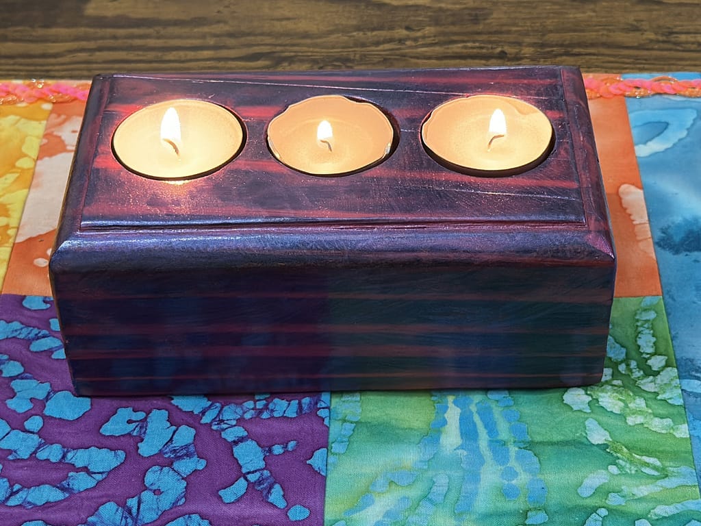 Magenta Mirage tealight holder displayed with tealights burning, vibrant colors visible