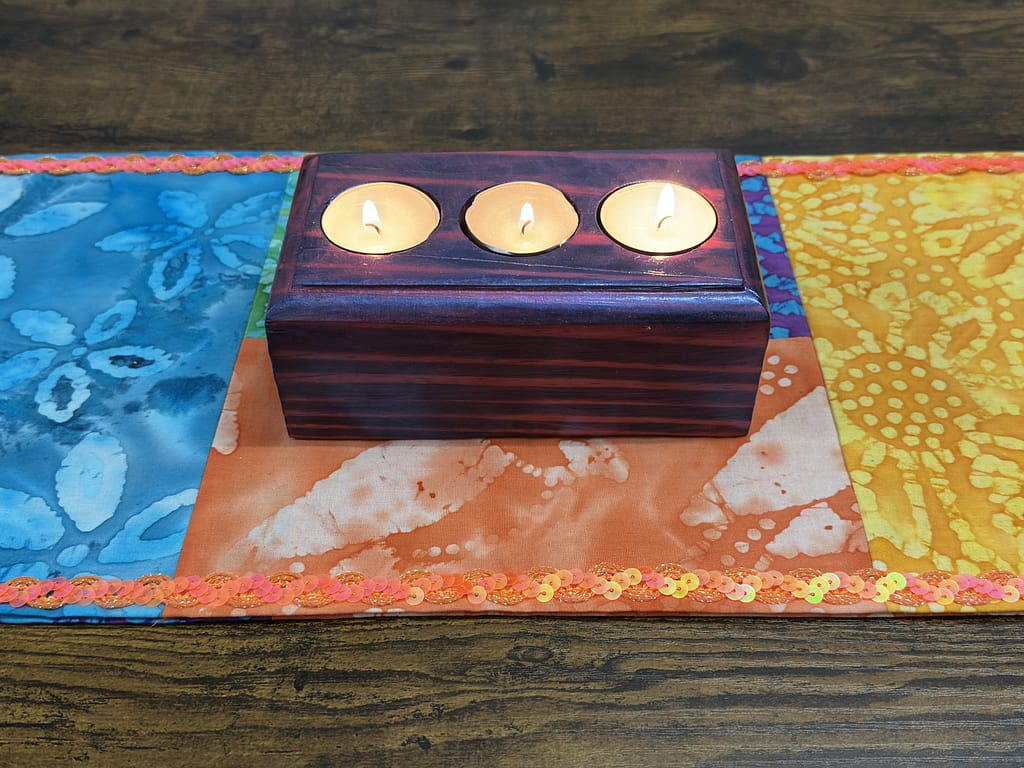 Finished Magenta Mirage tealight holder with candles lit