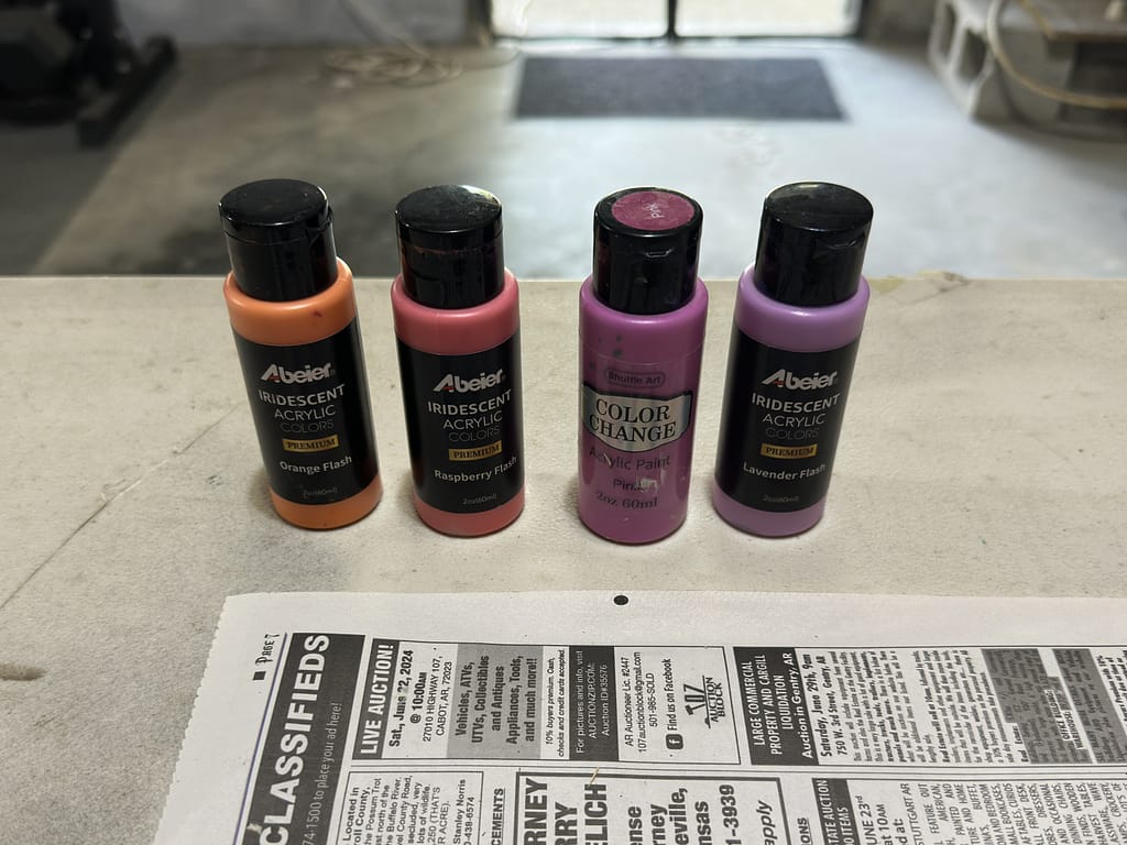 Selection of vibrant orange and complementary paint colors chosen for the Starlit Showgirl art piece.