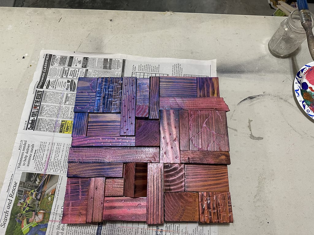 Completed Starlit Showgirl artwork with a glossy polyurethane finish, highlighting the wood’s texture and vibrant painted colors.