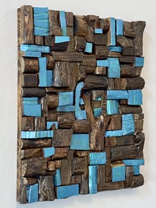 Angled view of the Chunky Murphy Mosaic showing layered reclaimed wood blocks and blue-green painted highlights.