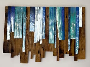 Close-up of Ocean Mist Mosaic wood wall art with layered blue, teal, and white vertical planks