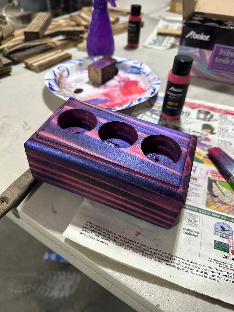 Tealight holder being painted magenta and purple