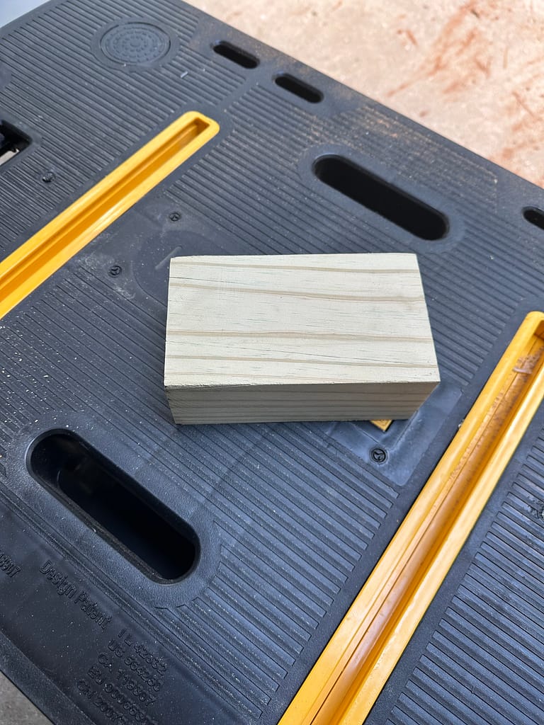 Block of pine wood on workbench before cutting.