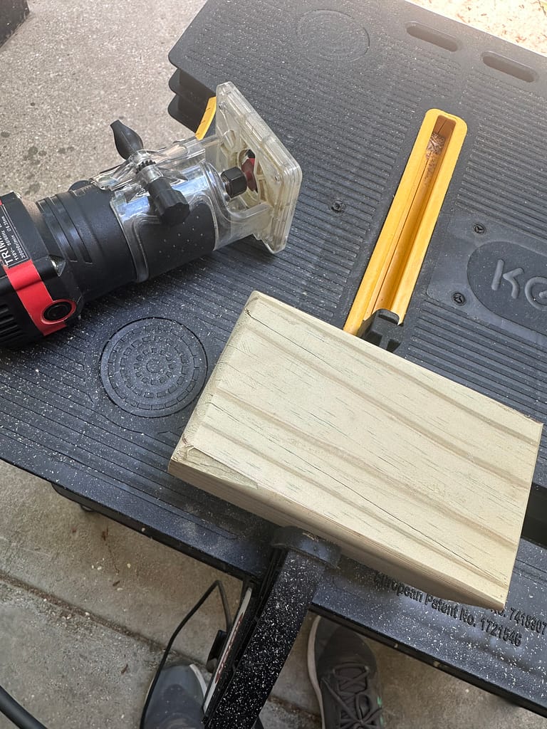 Pine block with routed edges, woodworking router visible