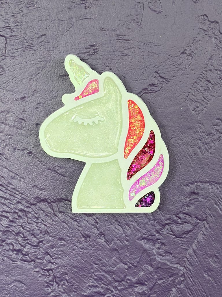 Close-up of unicorn wall art after glitter and epoxy finish, shimmering in the light.