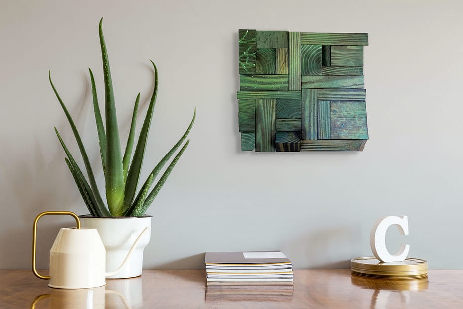Shou Sugi Ban geometric ombre mosaic wall art displayed above a modern table with an aloe plant.