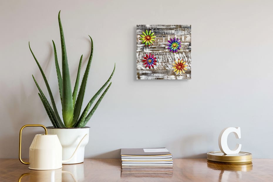 Spring Pallet Bloom Garden floral pallet wall art hanging above a desk with an aloe plant and books